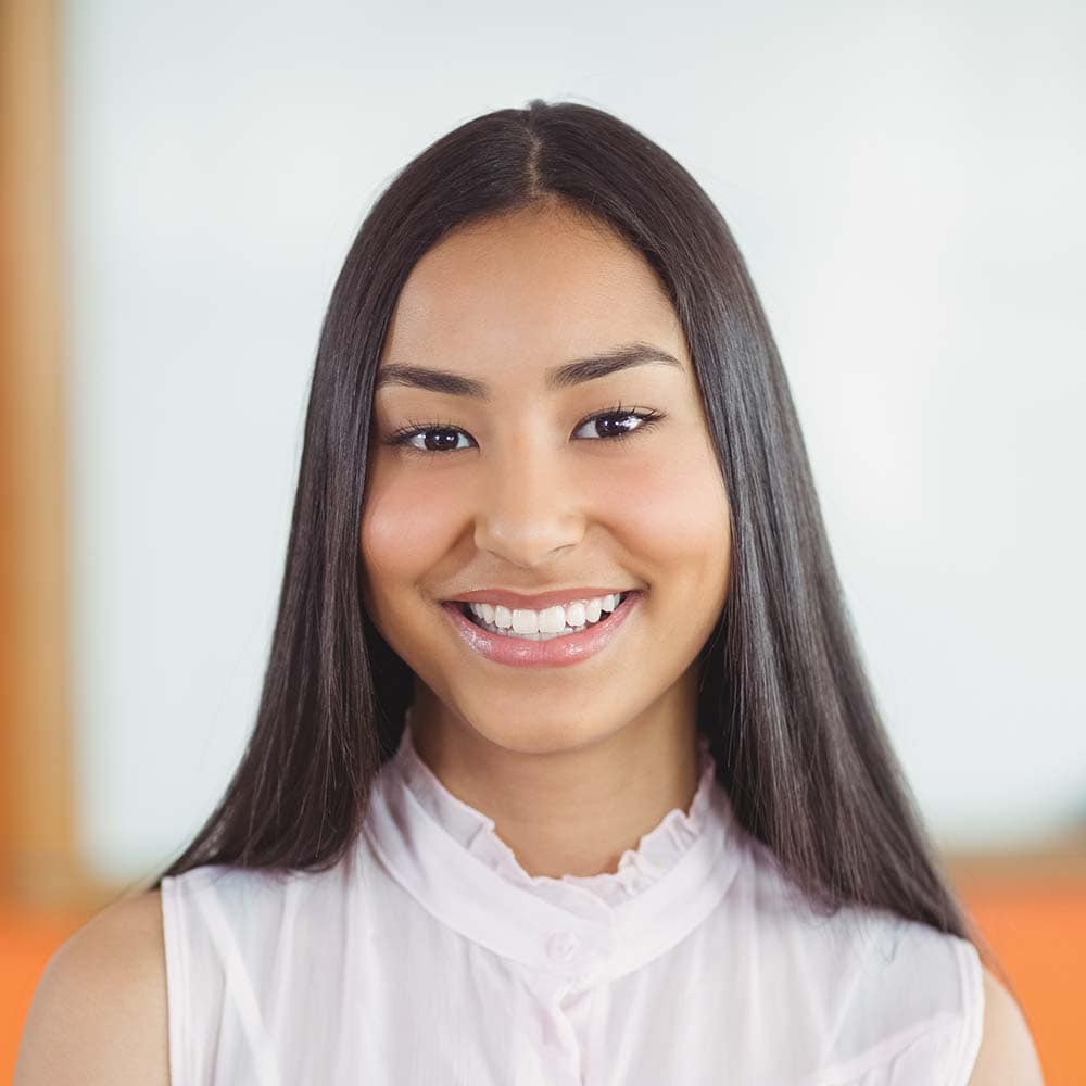 portrait of smiling schoolgirl in classroom RTAU255